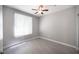 Bright, empty bedroom with grey walls, wood-look flooring, and a large window providing natural light at 4400 S Jones Blvd # 2075, Las Vegas, NV 89103