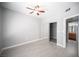 Comfortable bedroom with gray walls, ceiling fan, wood-look floors, and sliding door closet at 4400 S Jones Blvd # 2075, Las Vegas, NV 89103