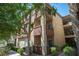 Exterior view of an apartment building with balconies and lush trees at 4400 S Jones Blvd # 2075, Las Vegas, NV 89103