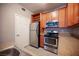 Functional kitchen features stainless steel appliances, wood cabinets, and stone-look countertop at 4400 S Jones Blvd # 2075, Las Vegas, NV 89103