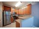Charming kitchen featuring stainless steel appliances, wood cabinets, and bright lighting fixtures at 4400 S Jones Blvd # 2075, Las Vegas, NV 89103