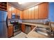 Efficient kitchen with stainless steel appliances, wooden cabinets, and neutral countertops at 4400 S Jones Blvd # 2075, Las Vegas, NV 89103