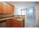 Cozy kitchen with wooden cabinetry, stainless steel sink, and an open layout with plenty of sunlight at 4400 S Jones Blvd # 2075, Las Vegas, NV 89103