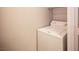 A white top-load washing machine sits in a small laundry area with white walls at 4400 S Jones Blvd # 2075, Las Vegas, NV 89103