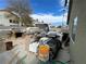 Backyard with cinder block fence, various building materials, and an old barbecue grill at 4568 Little Finch Ln, Las Vegas, NV 89115