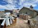 Spacious backyard with scattered building materials and a wooden storage shed to be customized at 4568 Little Finch Ln, Las Vegas, NV 89115