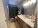 Functional bathroom features a single sink vanity, ample lighting, and a shower-tub combo at 4568 Little Finch Ln, Las Vegas, NV 89115