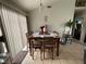 Inviting dining room features a wood table, chair set, and natural light from the window at 4568 Little Finch Ln, Las Vegas, NV 89115