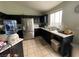 Modern kitchen with stainless steel refrigerator, dark cabinets, and ample counter space at 4568 Little Finch Ln, Las Vegas, NV 89115