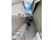 Exterior shot showing a narrow side yard with storage and walkway between two residential buildings at 4568 Little Finch Ln, Las Vegas, NV 89115