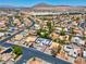 Aerial view of a desert community featuring single-Gathering homes, mature trees and desert landscaping at 4644 Canna Dr, Las Vegas, NV 89122