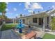 Large backyard patio with shade, a tiered fountain, and well-manicured lawn at 4644 Canna Dr, Las Vegas, NV 89122
