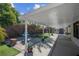 Backyard with patio, fountain, artificial grass, and shade structure at 4644 Canna Dr, Las Vegas, NV 89122