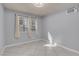 Bedroom featuring tiled floors, neutral walls, two windows with drapery, and window AC unit at 4644 Canna Dr, Las Vegas, NV 89122