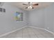 Neutral bedroom with tile floors, a ceiling fan, and natural light from the window at 4644 Canna Dr, Las Vegas, NV 89122