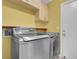 Laundry room with front loading stainless steel washer and dryer at 4644 Canna Dr, Las Vegas, NV 89122