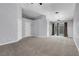 Large living room with vaulted ceilings, grey carpet, and sliding glass doors for natural light at 4644 Canna Dr, Las Vegas, NV 89122