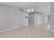Open-concept living room with tile flooring and large windows providing natural light at 4644 Canna Dr, Las Vegas, NV 89122