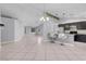 Open concept living area featuring tile floors, kitchen bar, and ample lighting at 4644 Canna Dr, Las Vegas, NV 89122
