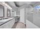 Bright main bathroom with double sinks, white cabinetry, walk-in shower, and natural light at 4644 Canna Dr, Las Vegas, NV 89122