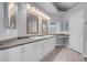 Main bathroom featuring double sinks, white cabinets, and modern lighting at 4644 Canna Dr, Las Vegas, NV 89122