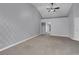 Spacious main bedroom featuring grey carpet, accent wall, neutral walls, and vaulted ceilings at 4644 Canna Dr, Las Vegas, NV 89122