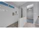 Modern walk-in shower with pebble floor and white subway tile at 4644 Canna Dr, Las Vegas, NV 89122