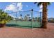 View of the community tennis court surrounded by palm trees and desert landscaping at 4644 Canna Dr, Las Vegas, NV 89122