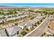 Expansive aerial view of a desert community showcasing well-maintained homes and stunning mountain views at 4893 E Cedar Creek Way, Pahrump, NV 89061