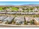 Wide aerial view of the desert community with an adjacent golf course and a serene pond at 4893 E Cedar Creek Way, Pahrump, NV 89061