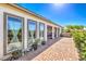 Well-kept backyard with pavers, lush landscaping, and a covered patio with a hot tub at 4893 E Cedar Creek Way, Pahrump, NV 89061