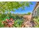 Lush backyard oasis with a hot tub, mature trees, colorful plants, and a garden, perfect for relaxation at 4893 E Cedar Creek Way, Pahrump, NV 89061