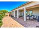 Spacious backyard patio featuring comfortable seating, BBQ, shade, and lush landscaping creating a tranquil outdoor living space at 4893 E Cedar Creek Way, Pahrump, NV 89061