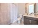 Well-lit bathroom with modern vanity, toilet, and stylish shower curtain that creates a spa-like experience at 4893 E Cedar Creek Way, Pahrump, NV 89061