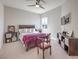 Inviting bedroom featuring a ceiling fan, TV, a comfortable bed with stylish décor, and natural light at 4893 E Cedar Creek Way, Pahrump, NV 89061