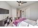 Comfortable bedroom showcasing a ceiling fan, TV, a cozy bed with a purple throw, and stylish décor at 4893 E Cedar Creek Way, Pahrump, NV 89061