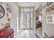 Bright entryway with white tile flooring, modern door with sidelights, and stylish decor at 4893 E Cedar Creek Way, Pahrump, NV 89061