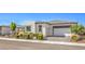 Attractive single-story home featuring neutral tones, a desert landscape, and an attached garage at 4893 E Cedar Creek Way, Pahrump, NV 89061