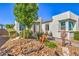 The exterior of this house shows stone landscaping, trimmed shrubs, and neutral stucco at 4893 E Cedar Creek Way, Pahrump, NV 89061