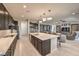 Contemporary kitchen featuring a large island, pendant lighting, and stainless steel appliances at 4893 E Cedar Creek Way, Pahrump, NV 89061