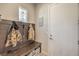 Functional mudroom with built-in bench, coat hooks, and storage, next to the entry door and featuring a transom window at 4893 E Cedar Creek Way, Pahrump, NV 89061