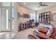 Bright home office with large windows, stylish furnishings, and a comfortable seating area at 4893 E Cedar Creek Way, Pahrump, NV 89061