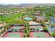 Expansive aerial view of a golf course, tennis courts, and community at 5067 Pensier St, Las Vegas, NV 89135