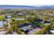 Gorgeous aerial view of a luxury community featuring lush landscaping, tennis courts, and a sparkling pool at 5067 Pensier St, Las Vegas, NV 89135