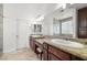 Bathroom with granite countertop, dual sinks, and shower with glass block window at 5067 Pensier St, Las Vegas, NV 89135