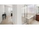 Bathroom showcasing separate tub, shower, and vanity areas with large glass block window at 5067 Pensier St, Las Vegas, NV 89135