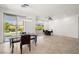 Well-lit dining area with modern chandelier and views of the landscaped backyard at 5067 Pensier St, Las Vegas, NV 89135