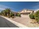 Charming home with a paved driveway, well-manicured landscaping, and a two-car garage at 5067 Pensier St, Las Vegas, NV 89135