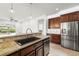 Stylish kitchen with granite counters, stainless appliances, and backyard view at 5067 Pensier St, Las Vegas, NV 89135