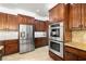 Modern kitchen boasts stainless steel appliances, and ample cabinet space for storage at 5067 Pensier St, Las Vegas, NV 89135